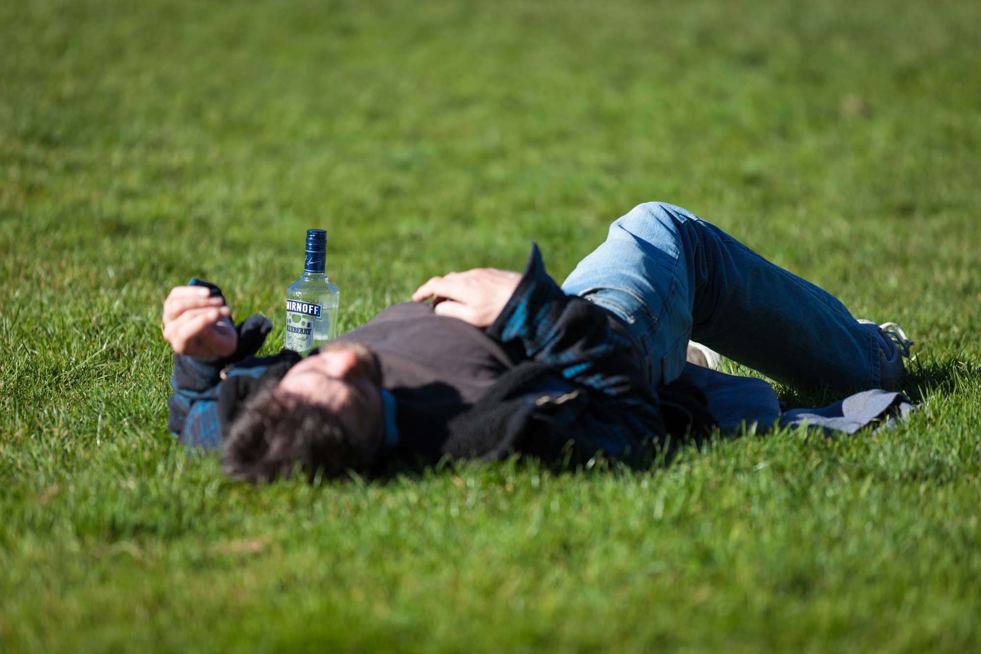 Drunk man laying in grass