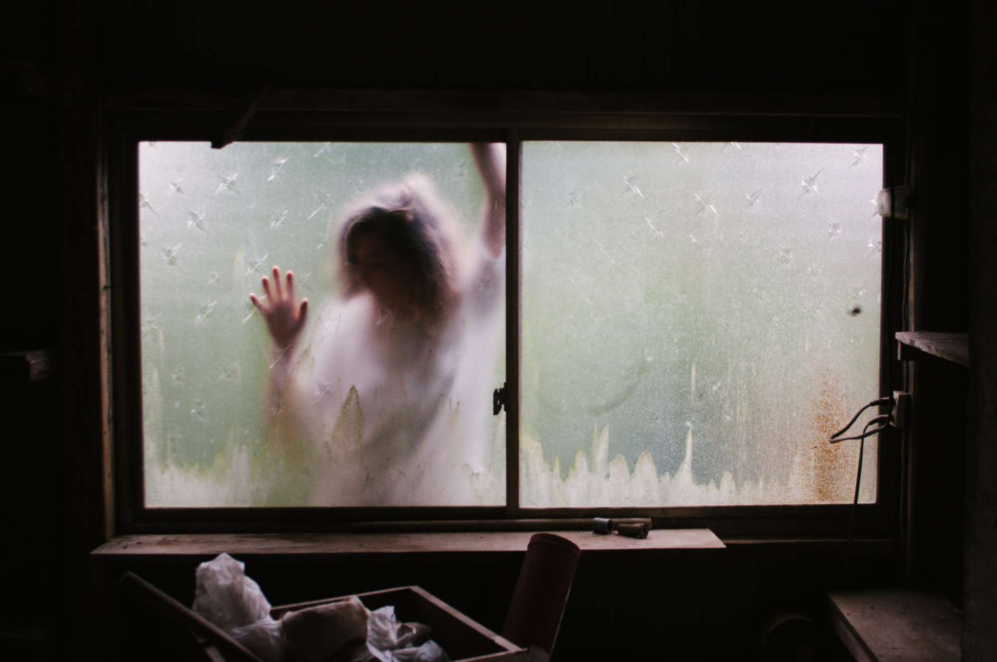 Woman behind a blurry window 